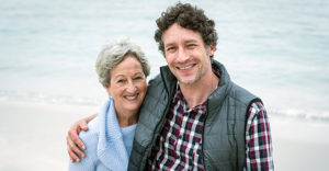 Son and mother smiling together