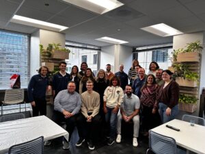 Topel Forman tax consultants and staff gathered for a team photo in the office, celebrating collaboration and client service in tax and advisory.