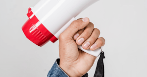 hand holding megaphone representing alertness for responding to IRS notices